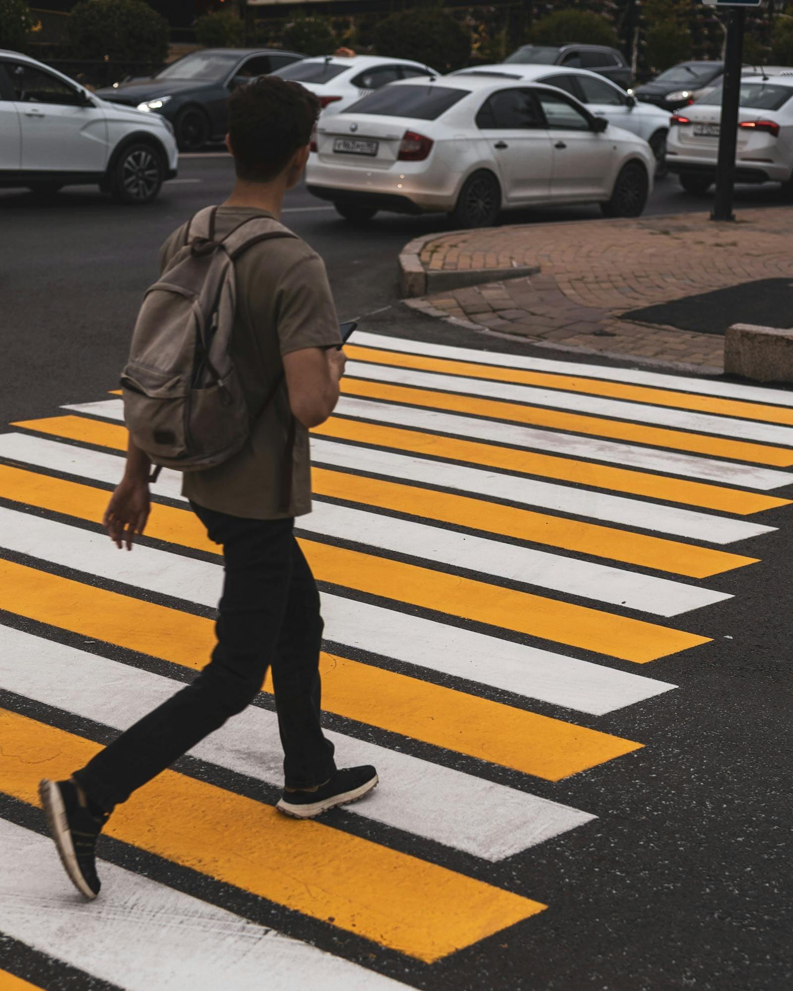 Pedestrian crossing on a wet Sydney street at dusk