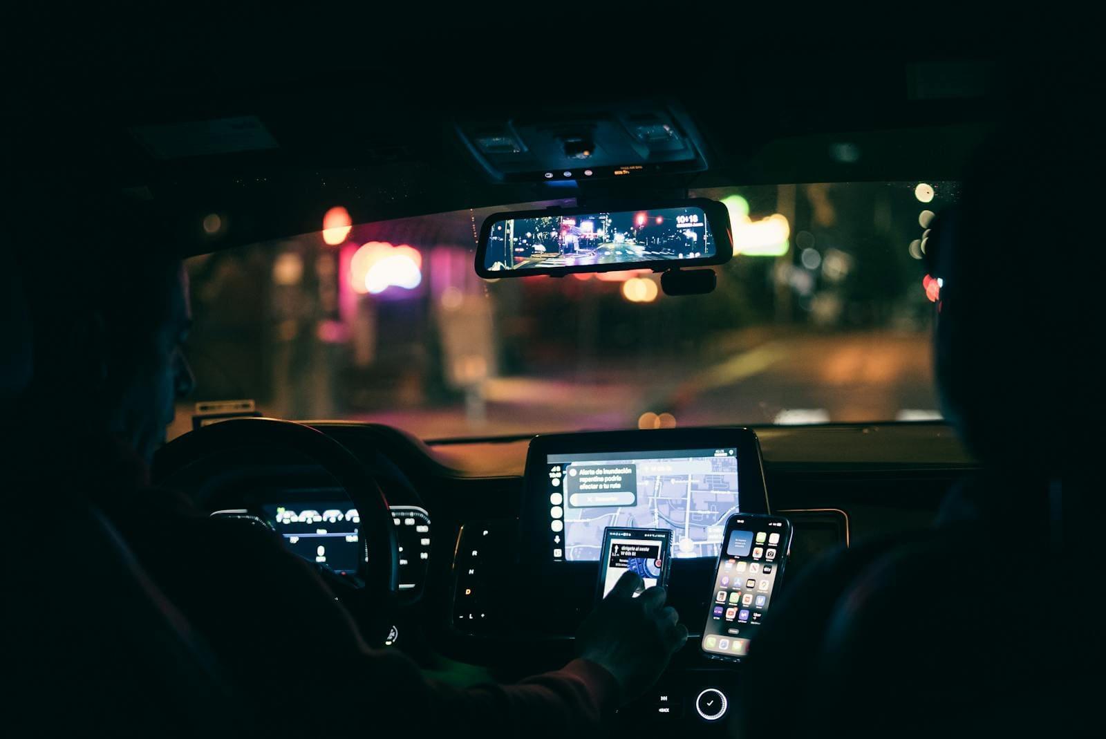 Rideshare driver with phone mounted to windscreen at a Sydney intersection